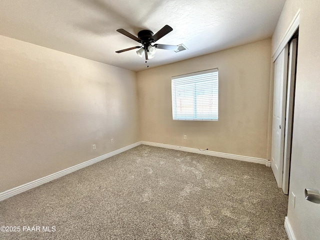 unfurnished bedroom with visible vents, ceiling fan, baseboards, carpet floors, and a closet