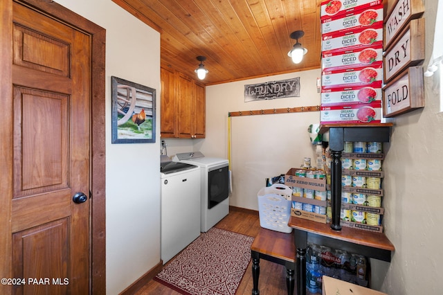 clothes washing area with washing machine and clothes dryer, cabinet space, wooden ceiling, and wood finished floors