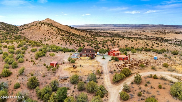 birds eye view of property with a rural view, a mountain view, and view of desert