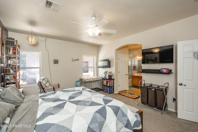 248 Lakewood Cv, Prescott, AZ 86301 - bedroom with arched walkways, multiple windows, light colored carpet, and ceiling fan