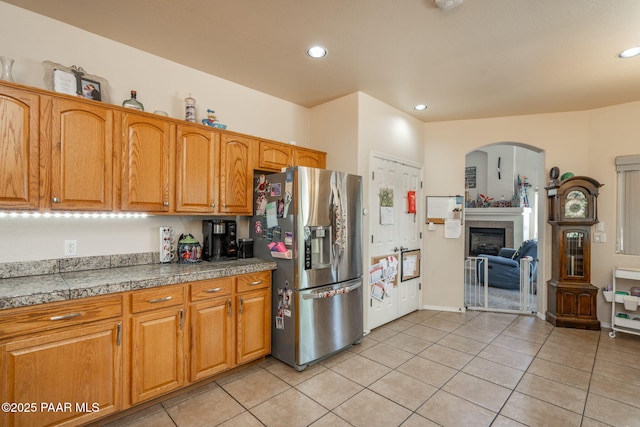 248 Lakewood Cv, Prescott, AZ 86301 - kitchen with stainless steel fridge with ice dispenser, tile counters, light tile patterned floors, arched walkways, and recessed lighting