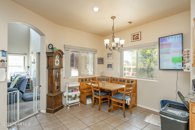 248 Lakewood Cv, Prescott, AZ 86301 - dining room featuring arched walkways, light tile patterned floors, a chandelier, baseboards, and recessed lighting