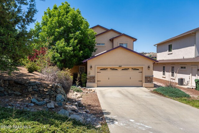 248 Lakewood Cv, Prescott, AZ 86301 - view of front of property featuring central AC, stucco siding, a garage, stone siding, and driveway