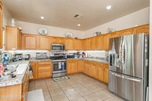 248 Lakewood Cv, Prescott, AZ 86301 - kitchen with stainless steel appliances, a sink, light countertops, light tile patterned flooring, and recessed lighting