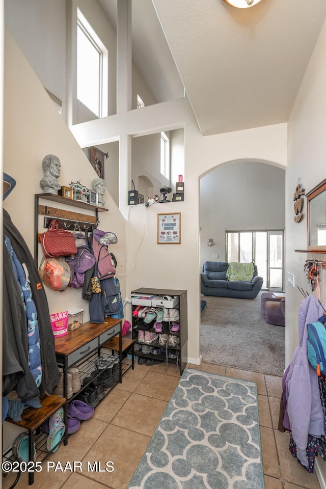 248 Lakewood Cv, Prescott, AZ 86301 - corridor with arched walkways, tile patterned flooring, plenty of natural light, and a towering ceiling