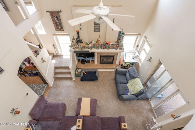 248 Lakewood Cv, Prescott, AZ 86301 - living area with a towering ceiling, a ceiling fan, plenty of natural light, stairs, and carpet floors