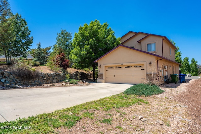 248 Lakewood Cv, Prescott, AZ 86301 - view of front facade with concrete driveway, a garage, and stucco siding