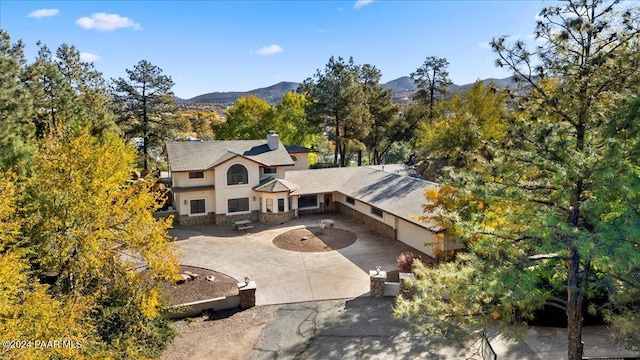 birds eye view of property featuring a mountain view