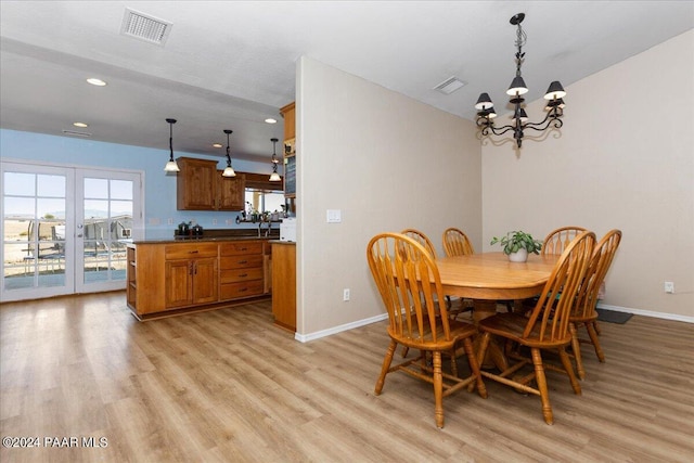 dining area featuring a chandelier and light hardwood / wood-style flooring