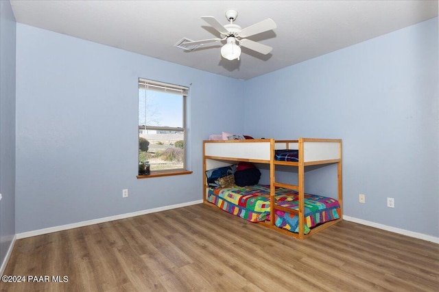 bedroom with ceiling fan and wood-type flooring