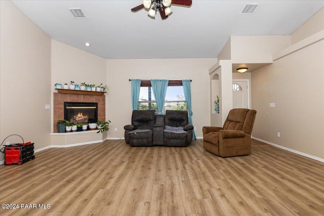 living room with ceiling fan and light hardwood / wood-style flooring