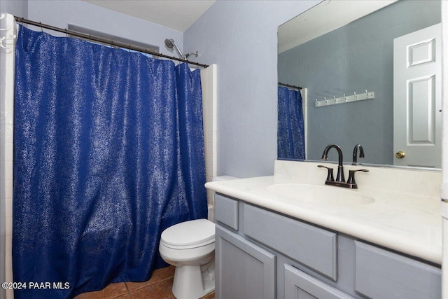 bathroom featuring tile patterned flooring, vanity, toilet, and a shower with shower curtain