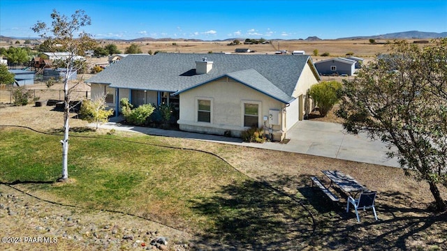 exterior space featuring a front yard and a mountain view