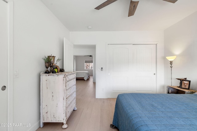 bedroom with ceiling fan, a closet, and light wood-type flooring