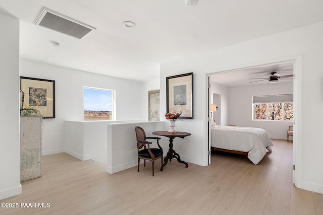 corridor with plenty of natural light and light hardwood / wood-style floors