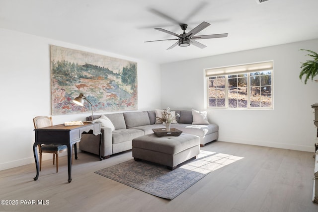 living room featuring ceiling fan and light wood-type flooring