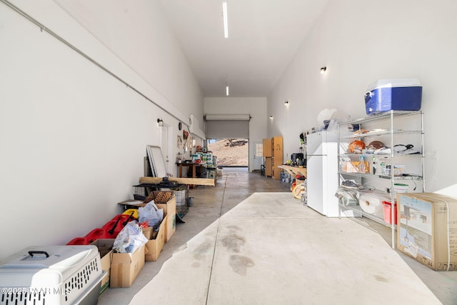 garage with a workshop area and white refrigerator