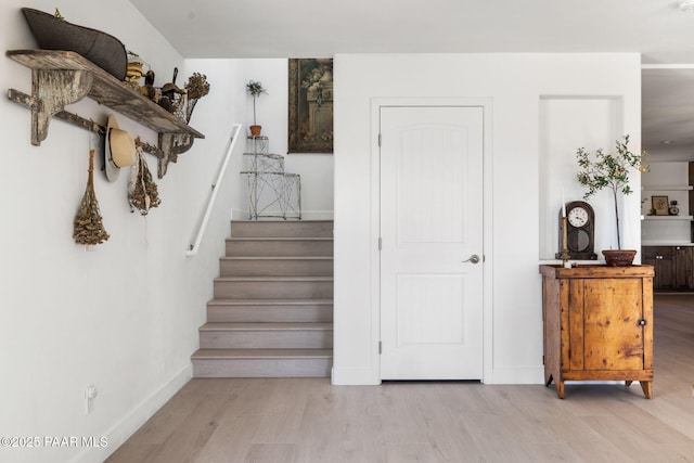 stairway with hardwood / wood-style flooring