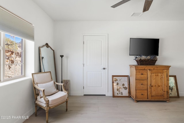 sitting room featuring light hardwood / wood-style flooring and ceiling fan