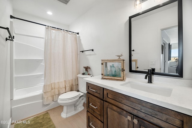 full bathroom with vanity, hardwood / wood-style floors, toilet, and shower / bath combo with shower curtain