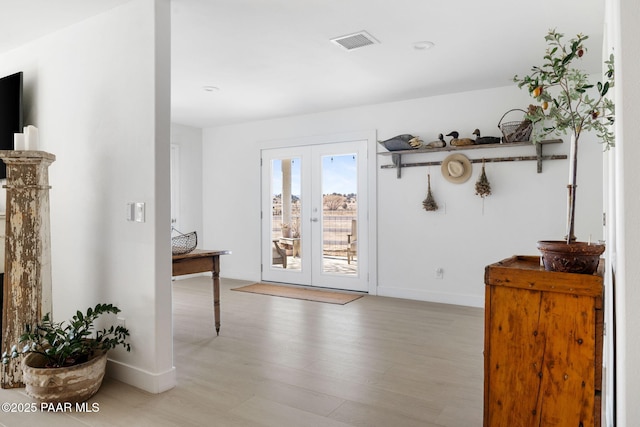 doorway to outside with french doors and light wood-type flooring