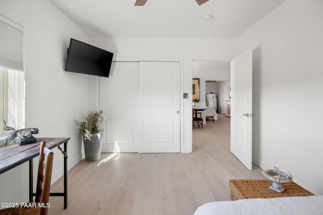 bedroom with ceiling fan, a closet, and light wood-type flooring