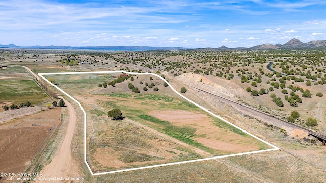 birds eye view of property featuring a mountain view and a rural view