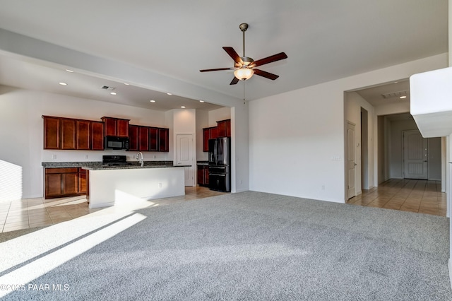 kitchen featuring ceiling fan, sink, an island with sink, light colored carpet, and black appliances