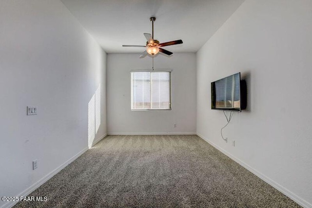 unfurnished room with ceiling fan and light colored carpet