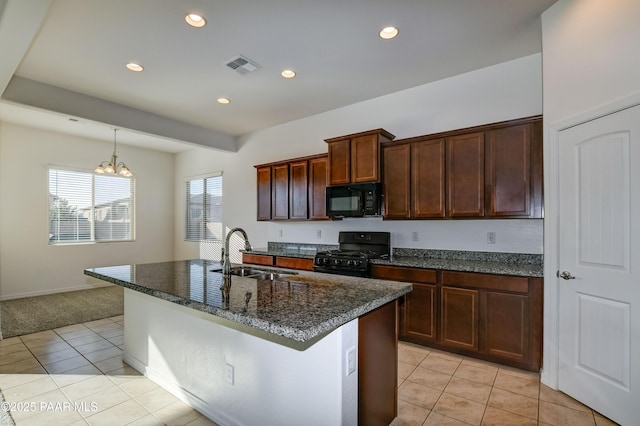 kitchen with a kitchen island with sink, sink, black appliances, a chandelier, and light tile patterned flooring