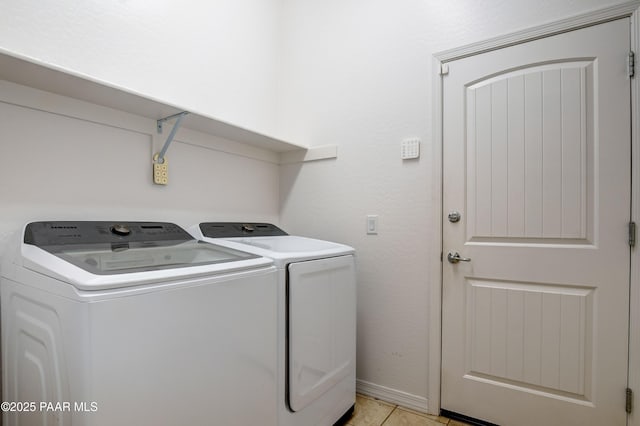 laundry area featuring separate washer and dryer and light tile patterned flooring