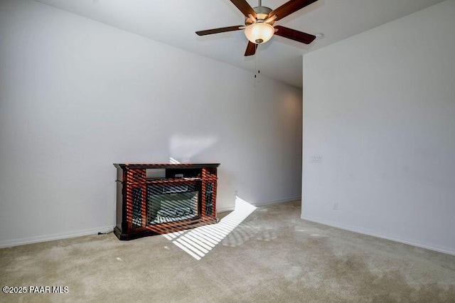 unfurnished living room featuring ceiling fan and light colored carpet