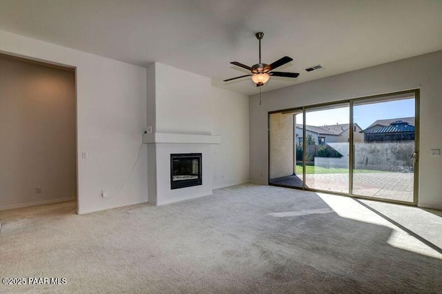 unfurnished living room featuring ceiling fan and light colored carpet