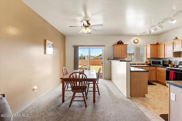 12912 E Santiago St, Dewey-Humboldt, AZ 86327 - kitchen featuring white gas range oven, stainless steel microwave, under cabinet range hood, a ceiling fan, and dark countertops