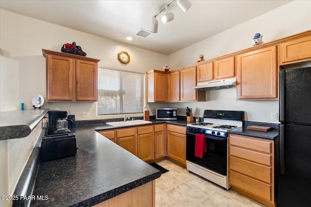 12912 E Santiago St, Dewey-Humboldt, AZ 86327 - kitchen featuring freestanding refrigerator, range with gas stovetop, under cabinet range hood, stainless steel microwave, and track lighting