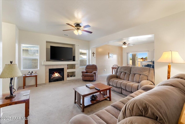 12912 E Santiago St, Dewey-Humboldt, AZ 86327 - carpeted living area featuring a ceiling fan and a tile fireplace