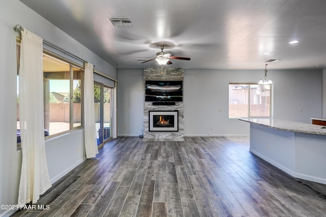 7506 E Roaring Canyon Rd, Prescott Valley, AZ 86315 - unfurnished living room with ceiling fan, dark wood-style flooring, a large fireplace, and recessed lighting
