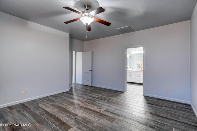 7506 E Roaring Canyon Rd, Prescott Valley, AZ 86315 - unfurnished bedroom with dark wood-style flooring, connected bathroom, and ceiling fan