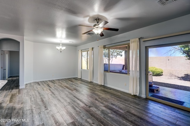 7506 E Roaring Canyon Rd, Prescott Valley, AZ 86315 - unfurnished room featuring arched walkways, ceiling fan, wood finished floors, and a chandelier
