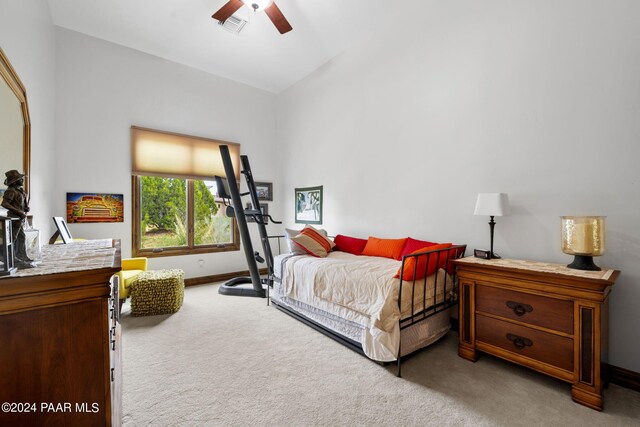 bedroom with ceiling fan, carpet, and high vaulted ceiling