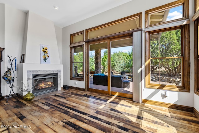 entryway with a high end fireplace and hardwood / wood-style flooring