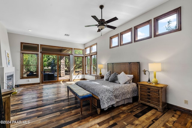 bedroom featuring ceiling fan, access to exterior, and dark wood-type flooring