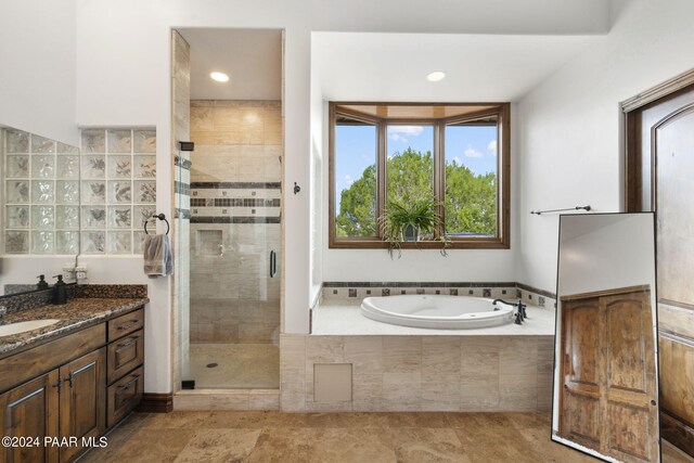 bathroom featuring vanity and separate shower and tub