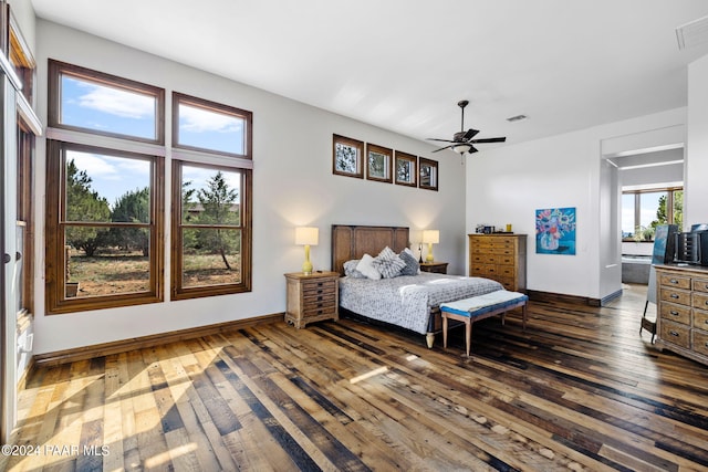 bedroom with ceiling fan and dark hardwood / wood-style floors