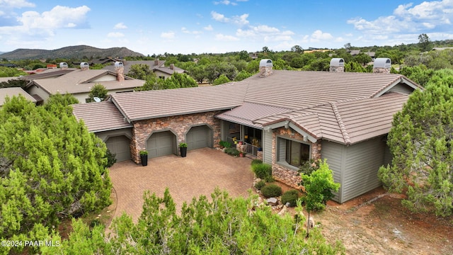 view of front of home with a mountain view and a garage