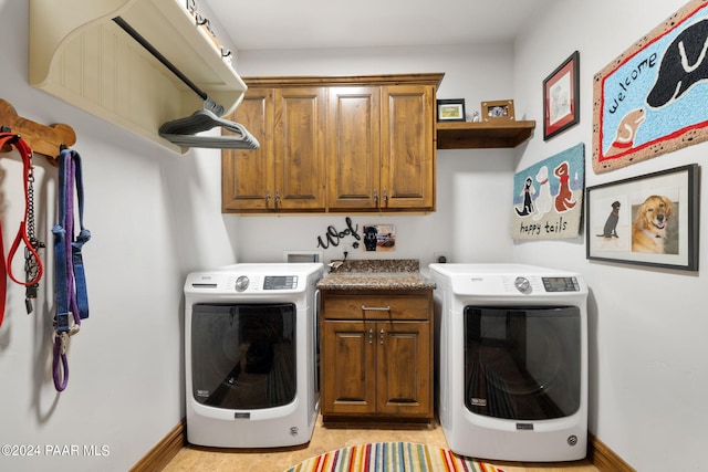 washroom with cabinets and washer / dryer