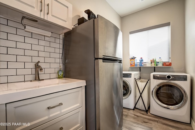 washroom featuring sink and light hardwood / wood-style flooring