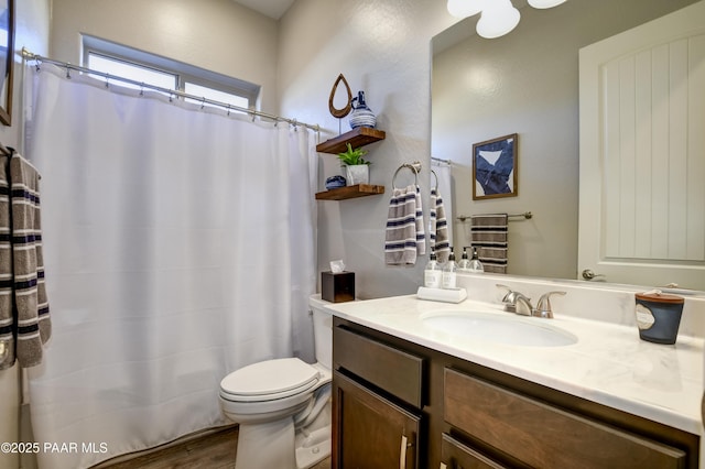 bathroom with hardwood / wood-style flooring, vanity, and toilet