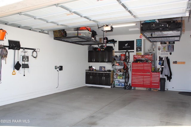 garage with a garage door opener and a workshop area