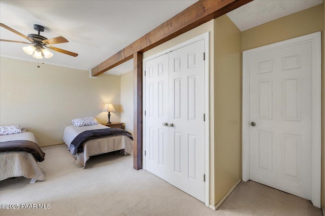bedroom with light carpet, a closet, a ceiling fan, and beamed ceiling